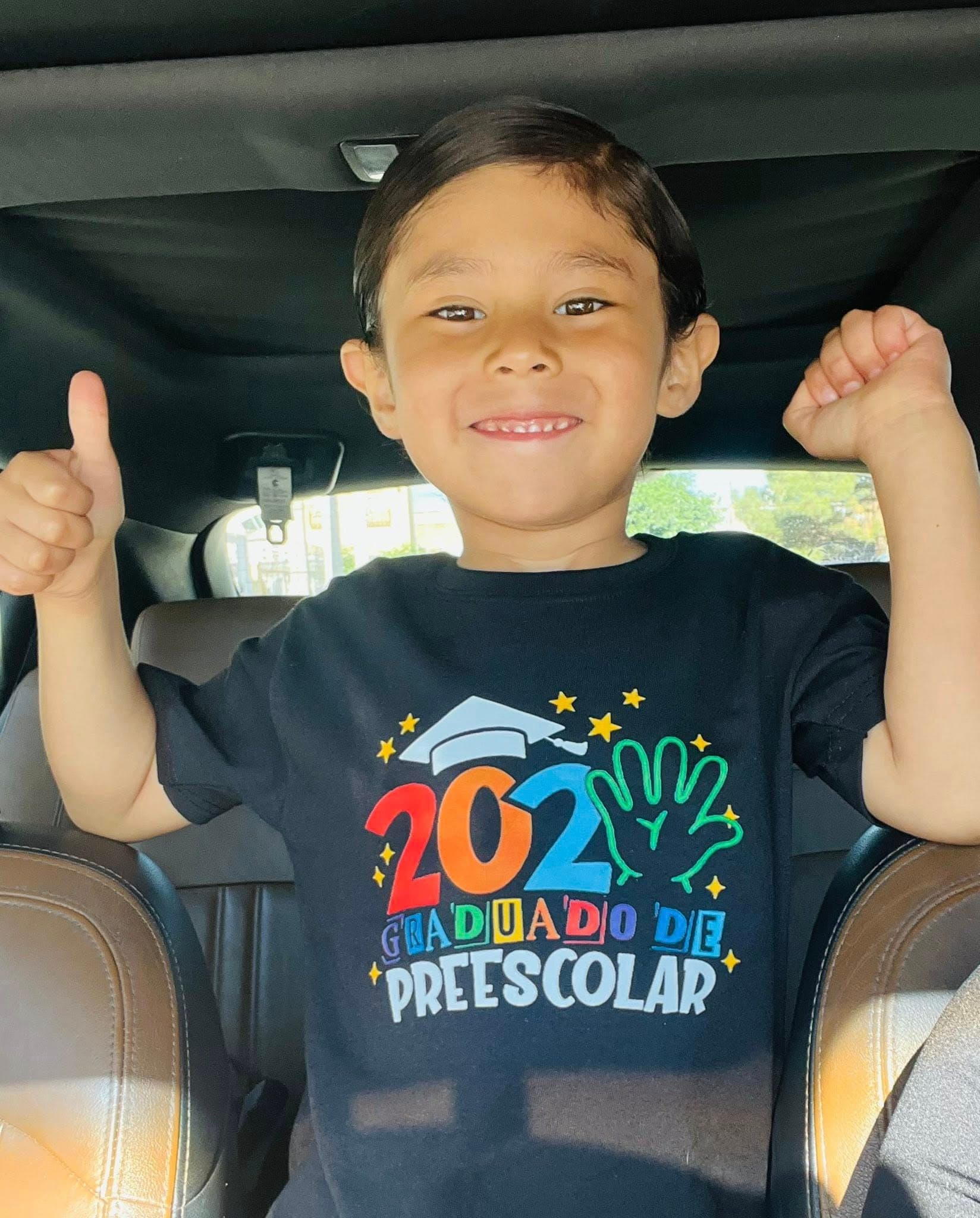 A child giving a thumbs up in custom Marcomania apparel